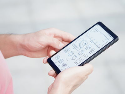 年轻人查看房贷APP显示利率下调后的月供信息