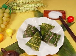 老人与孙子一起包粽子的画面