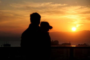 两人携手走在夕阳下