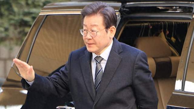 李在明手持成绩单在竞选现场