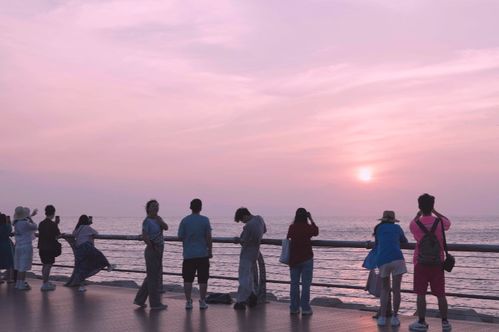 一群高中生在海边看日出合影留念