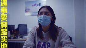 一个年轻女孩坐在办公室用电脑工作的场景